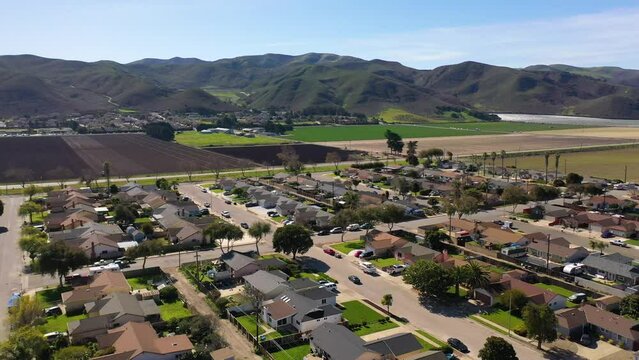 2023 - Excellent aerial footage approaching farmland by the mountains in Lompoc, California.