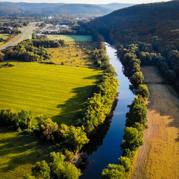 Valley view of farmland and river in very early fall, taken from an aerial view. 