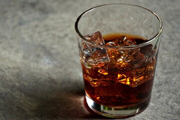 whiskey drink with cola served with ice cubes