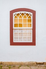 Paraty, Brazil. Colorful window with lace curtain of old colonial period house in historic downtown.