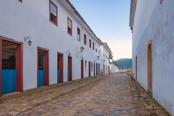 Paraty, Brazil. Houses with colorful doors and windows from the colonial period and stone street....