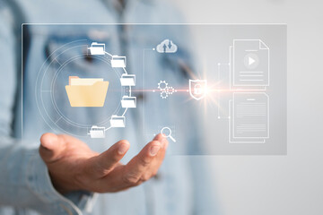 Document management system DMS, managing files data, paperless workflow, data search, cloud technology. Enterprise content management, Businessman working on laptop computer with digital document,