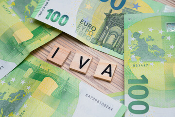 the inscription IVA or VAT in Italy next to euro banknotes. Concept showing value added tax