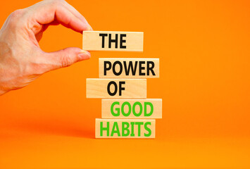 The power of good habits symbol. Concept words The power of good habits on wooden block. Beautiful orange table orange background. Businessman hand. Business power of good habits concept. Copy space.