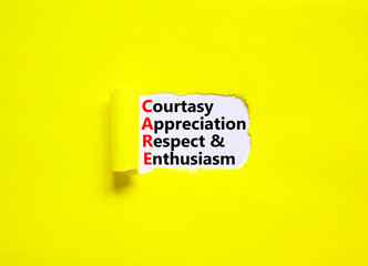 CARE symbol. Concept words CARE courtesy appreciation respect and enthusiasm on white paper on beautiful yellow background. Business CARE courtesy appreciation respect enthusiasm concept. Copy space.