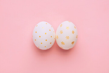 Easter handmade golden decorated eggs on pink background. Minimal easter concept. Flat Lay of Golden Easter Egg