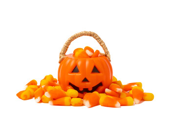 Corn candy in isolated on white background.Halloween concept. Bucket of Halloween pumpkin Jack-o-lantern with candy corn for halloween celebration.Pumpkin with a scary smile on his face.Candy bucket.