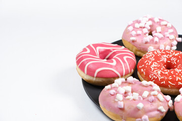 Donuts with red and pink glaze. Lots of donuts, sweet and delicious food, copy space for text, banner