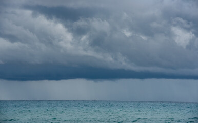 Seascape dramatic stormy clouds. Strom in the horizon. Rainy winter day in the ocean