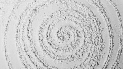 Texture of powder, flour, sand. White. Circle lines. Spiral. Textured, cracked. White. Banner, advertising. Empty space. For an inscription.