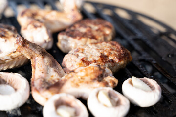 Meatballs, mushrooms, chicken and vegetables being cooked on grill. Selected focus. Seasonal photo. Camping, chilling  in garden, vacation time.