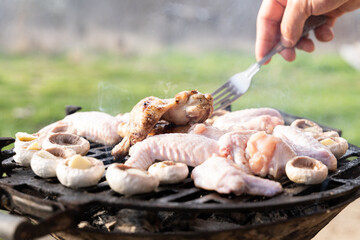 Meatballs, mushrooms, chicken and vegetables being cooked on grill. Selected focus. Seasonal photo. Camping, chilling  in garden, vacation time.