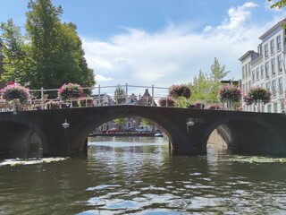 Traditional Dutch arch bridge over a canal, in the historic city of Leiden, Netherlands