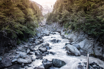 Hiking the Wonderland Trail around Mt. Rainier; mountain landscape with clouds; river in the mountains