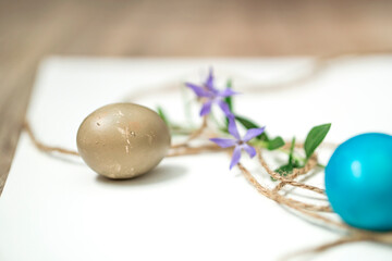 Naklejka na ściany i meble Easter eggs, twine and periwinkle on a white background. easter spring flowers. spring. greeting.