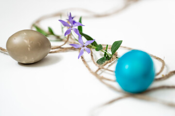 Easter eggs, twine and periwinkle on a white background. easter spring flowers. spring. greeting.