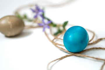 Easter eggs, twine and periwinkle on a white background. easter spring flowers. spring. greeting.