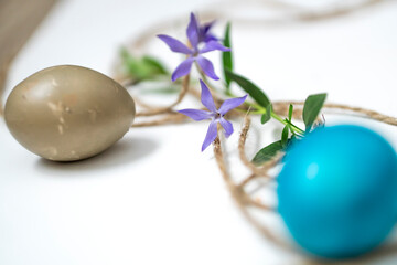 Easter eggs, twine and periwinkle on a white background. easter spring flowers. spring. greeting.