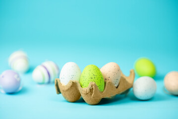 multi-colored painted Easter eggs on a blue background