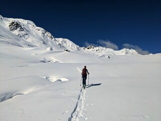 Ski tour in the beautiful swiss alps. Enjoy the beautifully snowy and untouched mountain landscape. Skitour in Davos Klosters Mountains. High quality photo