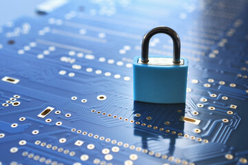 Cyber security concept blue background - padlock on blue computer motherboard circuit board 
