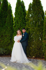 Fototapeta premium the bride and groom hugging and dancing in the park. 