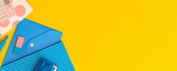 School stationery on a yellow background. Top view with copy space. Flat lay. Back to school concept.