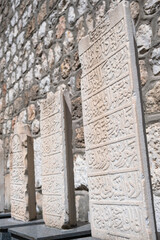 Fototapeta na wymiar Historical tombstones. Ruins of the Amasya ancient city. Archeological remains. Antique Ottoman headstone. Archaeological and mummies museum of Amasya