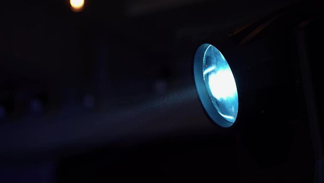 The work of lighting devices at a concert, disco or bar. Stage lighting work in a dark atmosphere at a concert, show, disco or celebration