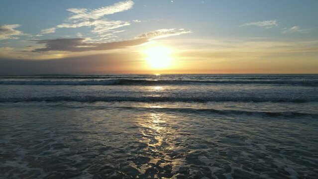 2022 - Excellent aerial footage of the sun setting over the waves at New Smyrna Beach, Florida.