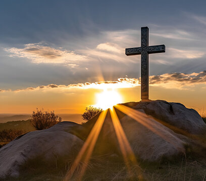 Religious cross on hill at sunset
