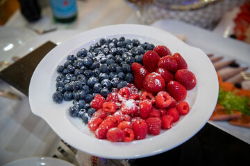 strawberries raspberries blueberries on a plate