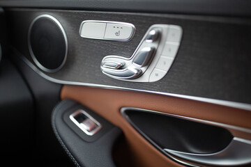 Naklejka premium modern car interior featuring a close-up shot of the control adjustment panel for the car seat