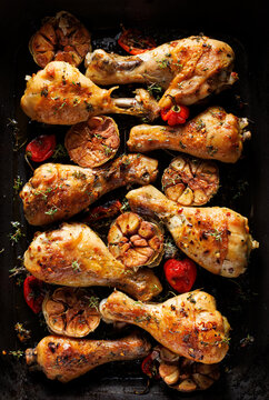 Grilled spicy chicken legs, drumsticks with addition of habanero peppers, garlic and herbs on a grilled plate, top view