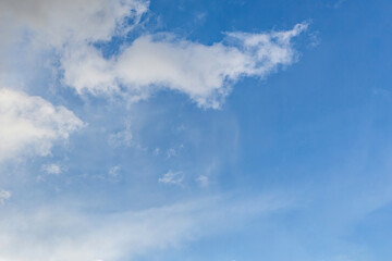 Beautiful blue sky with large white clouds backdrop. April weather spring sky background