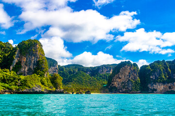 Tropical paradise turquoise water beach and limestone rocks Krabi Thailand.