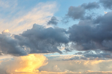 Fototapeta na wymiar Dramatic pastel sunset sky with large clouds backdrop