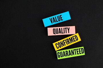 colored paper with the words Guaranteed Quality Value Assurance. The concept of ISO standards....