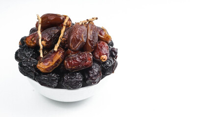Dates are a fruit that Muslims eat during Ramadan to break their fast. it served in white bowl