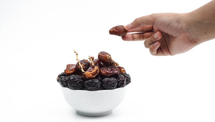 several dates, one of which is a hand picked, isolated on white background