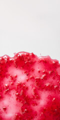 Raspberry jam on white background. Berry confiture closeup. Concept of sweet home canning. Vertical banner for stories, copy space