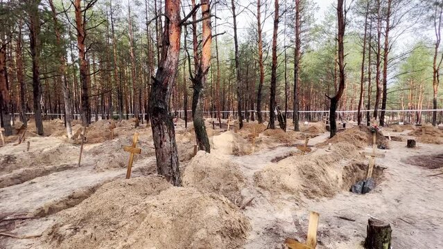 2022 - Mass graves suggest Russian war crimes and genocide in a forest in Izium, Ukraine following the regions liberation.