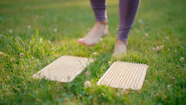 Slim Woman doing Sports in Park. Fit Lady Rolling out Mat and practising Meditation outside .Wellbeing. Healthy Lifestyle and Mindfullness. 4K wide panning shot