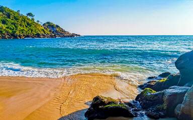 Beach sand blue water huge surfer waves Carrizalillo Puerto Escondido.