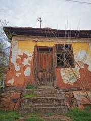an old abandoned house, made of mud, clay, wood and stone. building from natural materials