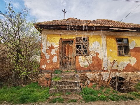 an old abandoned house, made of mud, clay, wood and stone. building from natural materials
