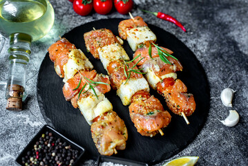 raw salmon skewers on skewers on a stone background.Raw seafood on skewers