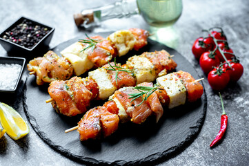 raw salmon skewers on skewers on a stone background.Raw seafood on skewers