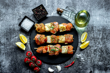 raw salmon skewers on skewers on a stone background.Raw seafood on skewers