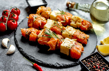 raw salmon skewers on skewers on a stone background.Raw seafood on skewers